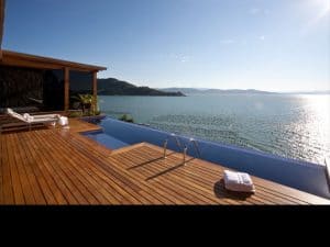 Guests look over a bay where oyster and mussel cultivation thrives—all while relaxing in the Special Emerald Villa’s long vanishing pool at Ponta dos Ganchos.