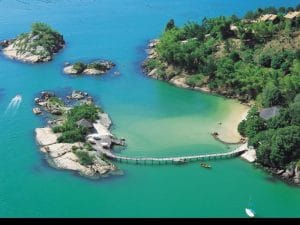 A bird’s eye view takes in Ponta dos Gancho’s lush hilltop grounds as well as the bridge that leads to the private cove beach dining room reserved for only one couple each evening.