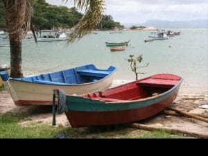 A nature hike takes guests past fishing boats of all sizes bobbing in the small bay below Ponta dos Ganchos.